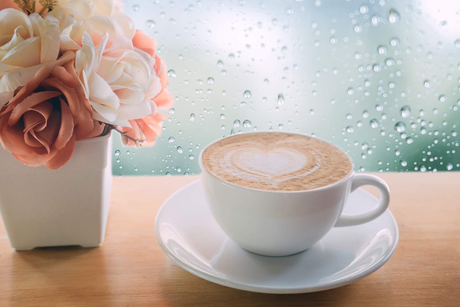 Coffee Cup on Wooden Table with Rain on the Window